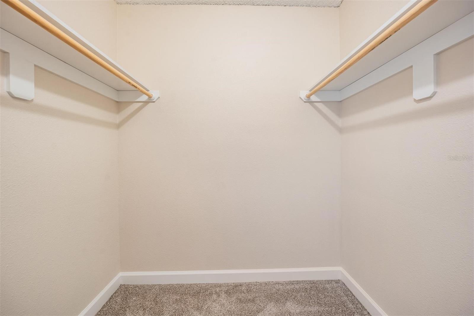 Primary bedroom walk in closet