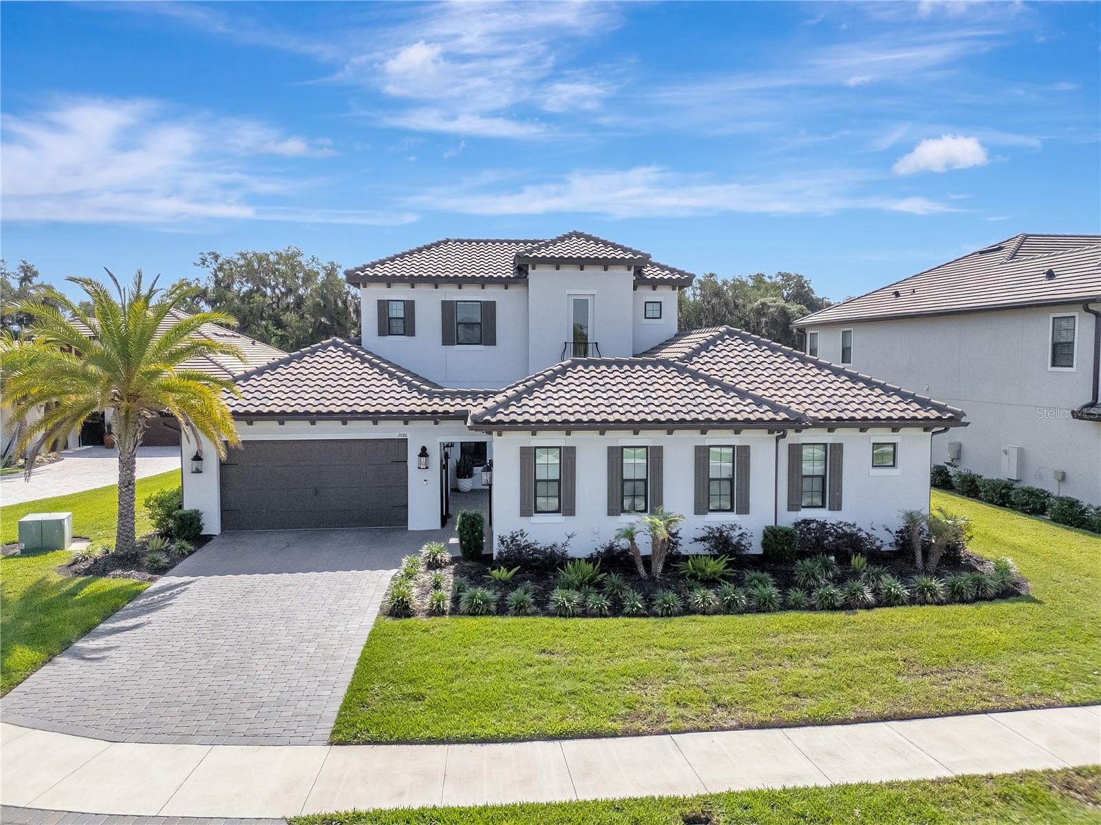 Beautiful Curb Appeal with Professional Landscaping and Pavered Driveway