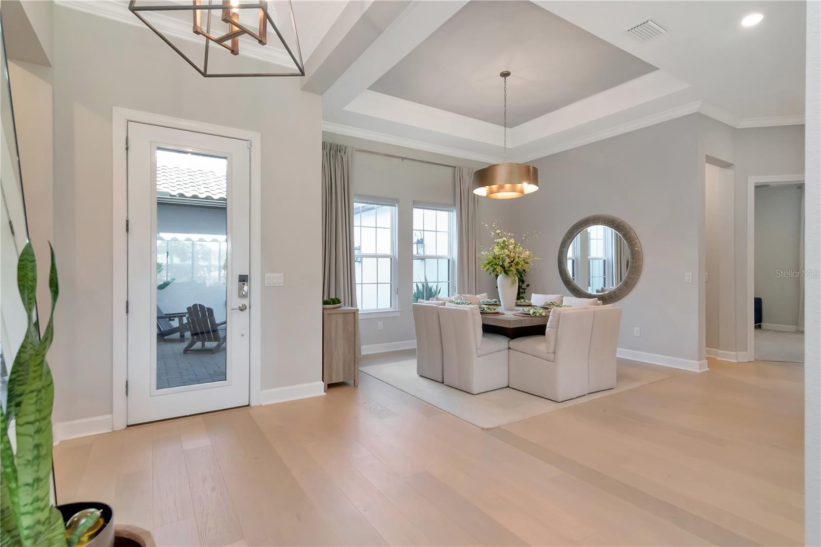 Open Ebtryway with Tray Ceilings and flooded with Natural Light