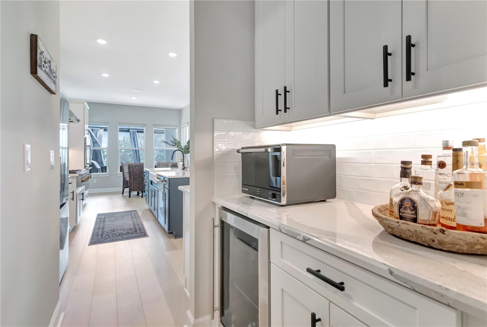 Dry bar adjacent to kitchen and formal dining space