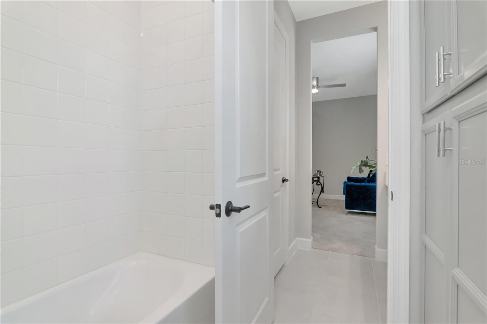 Bathroom 2 shared with Bedroom 2 and 3 featuring tiled tub/shower combo and oversized linen closet.