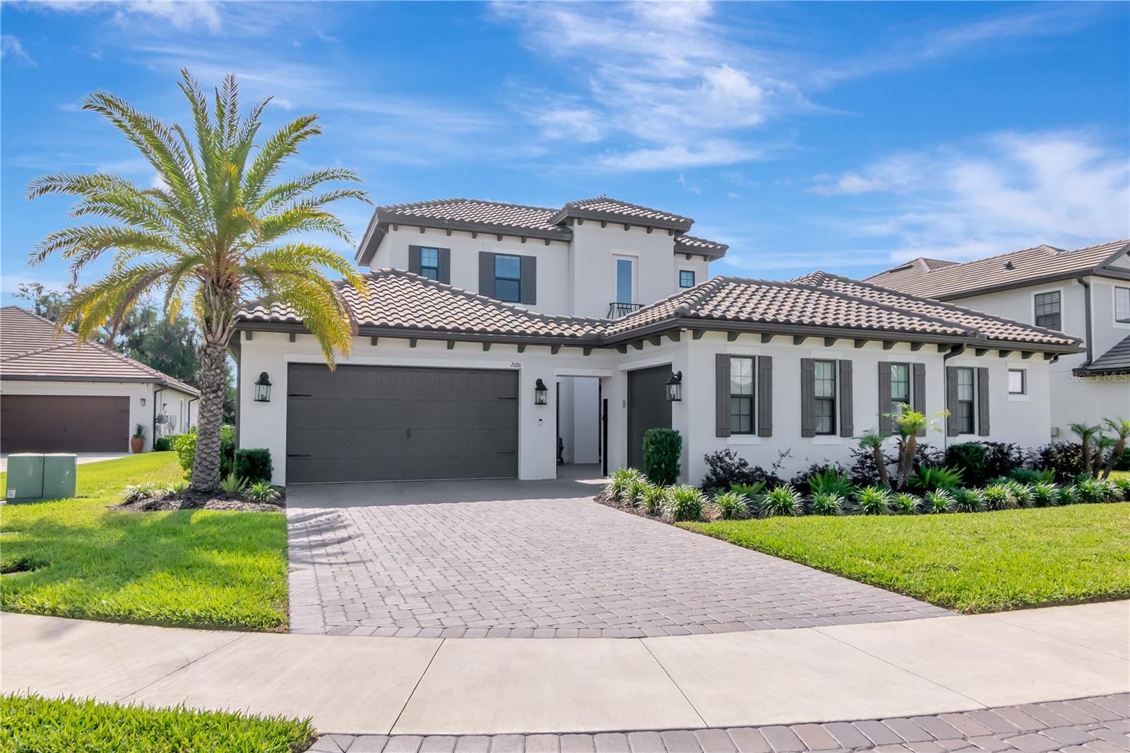 Beautiful Curb Appeal with Professional Landscaping and Pavered Driveway