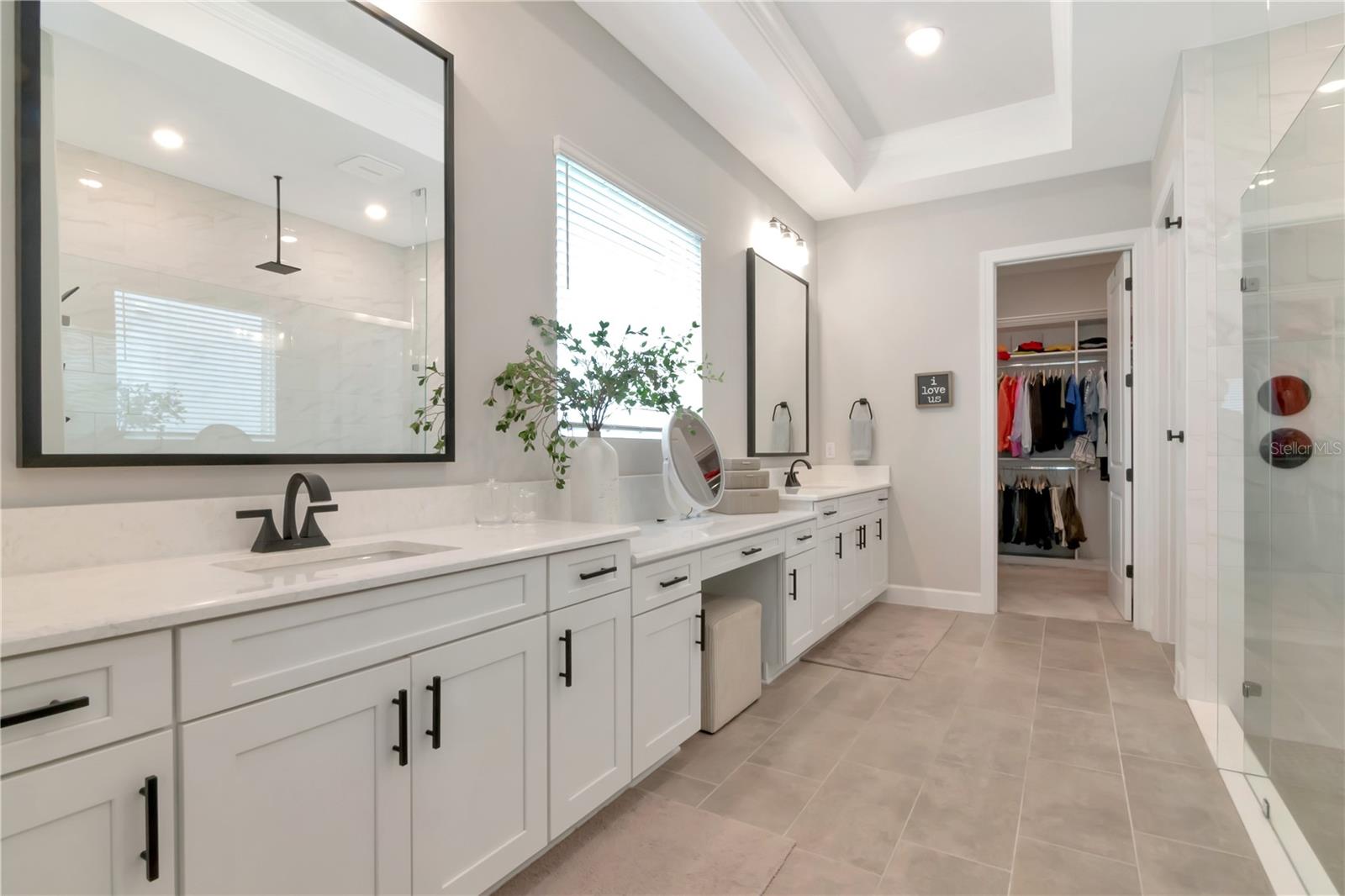 Primary Ensuite featuring endless, dual vanities, luxurious shower with dual showerheads and a custom walk in closet