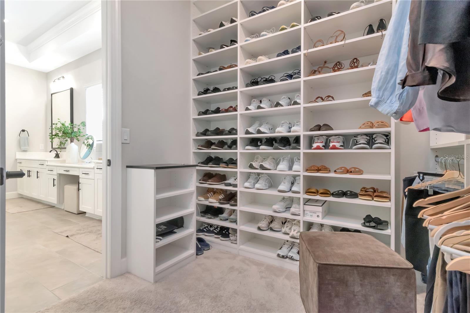 Large, custom walk in Primary Closet with built ins.