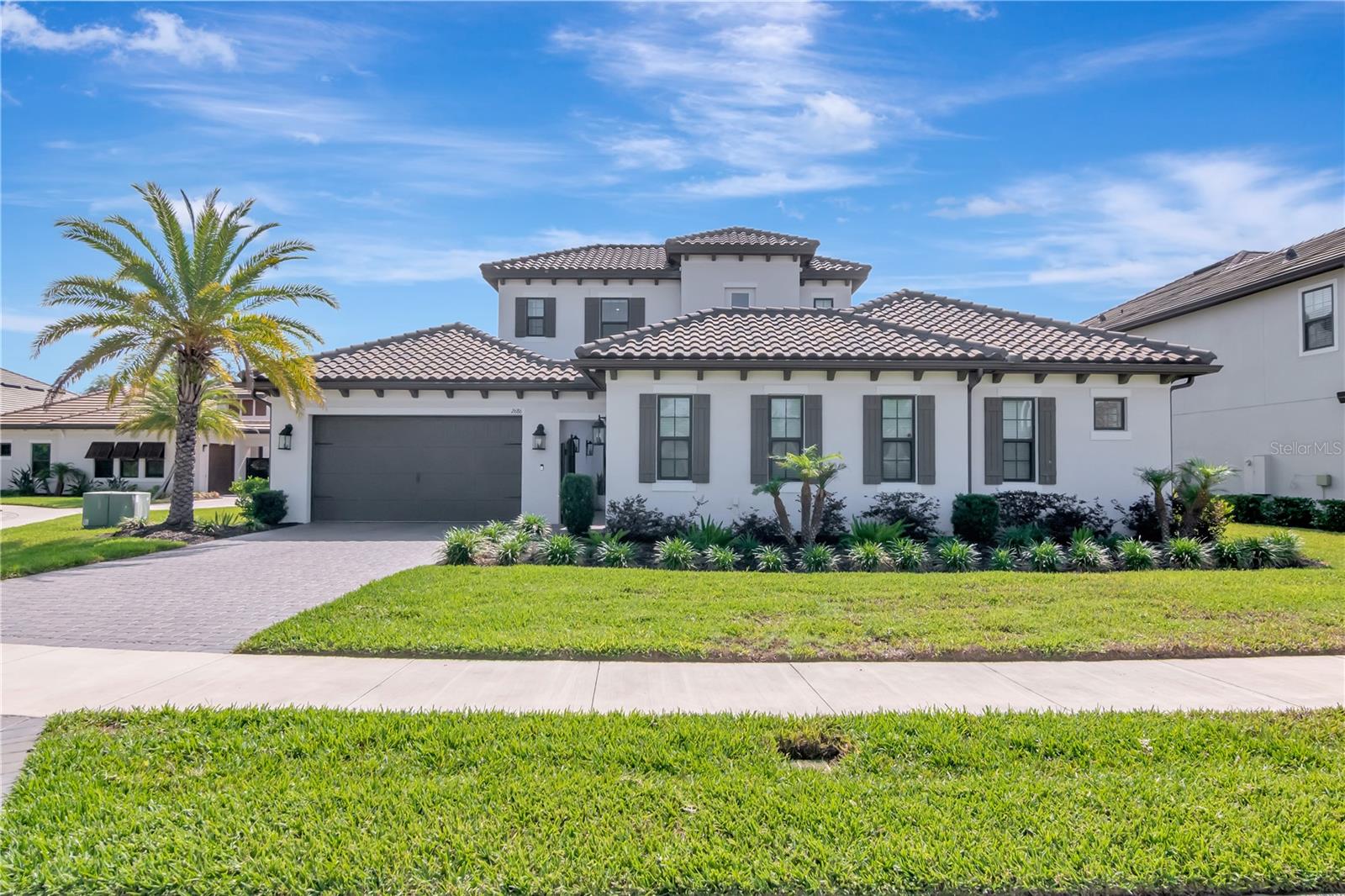 Beautiful Curb Appeal with Professional Landscaping and Pavered Driveway