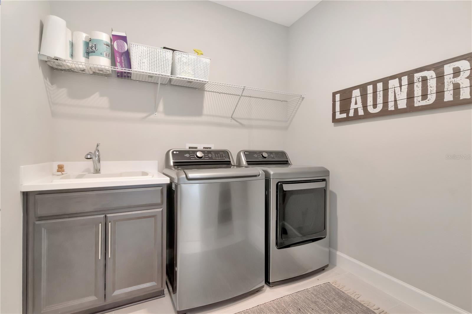 Laundry room complete with utility sink and addiitonal storage. Washer and Dryer do not convey.