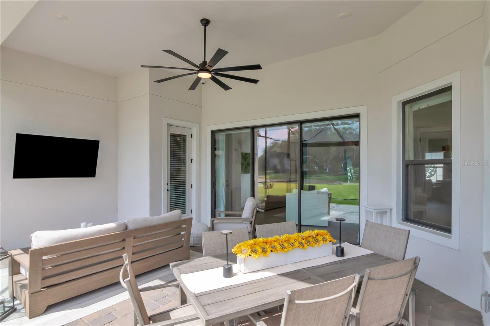 True Outdoor Living Space - Extended Lanai - Complete with panoramic screen, artificial turf, ceiling fan.