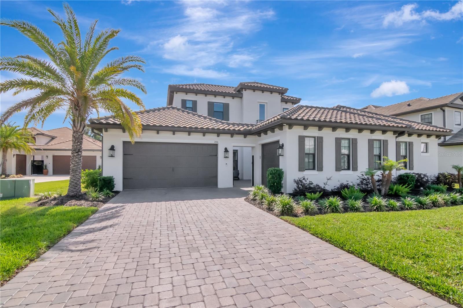 Beautiful Curb Appeal with Professional Landscaping and Pavered Driveway