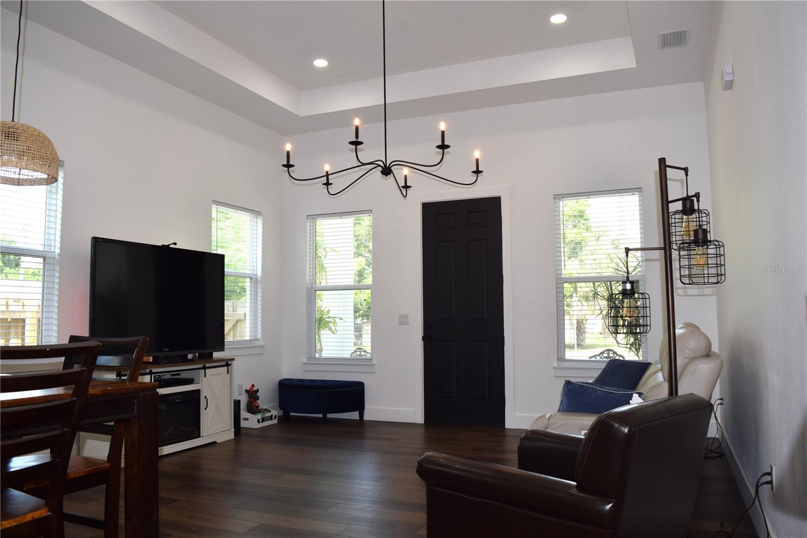 Great Room with High Ceilings is very light and bright, LED recessed lighting and a beautiful Chandelier