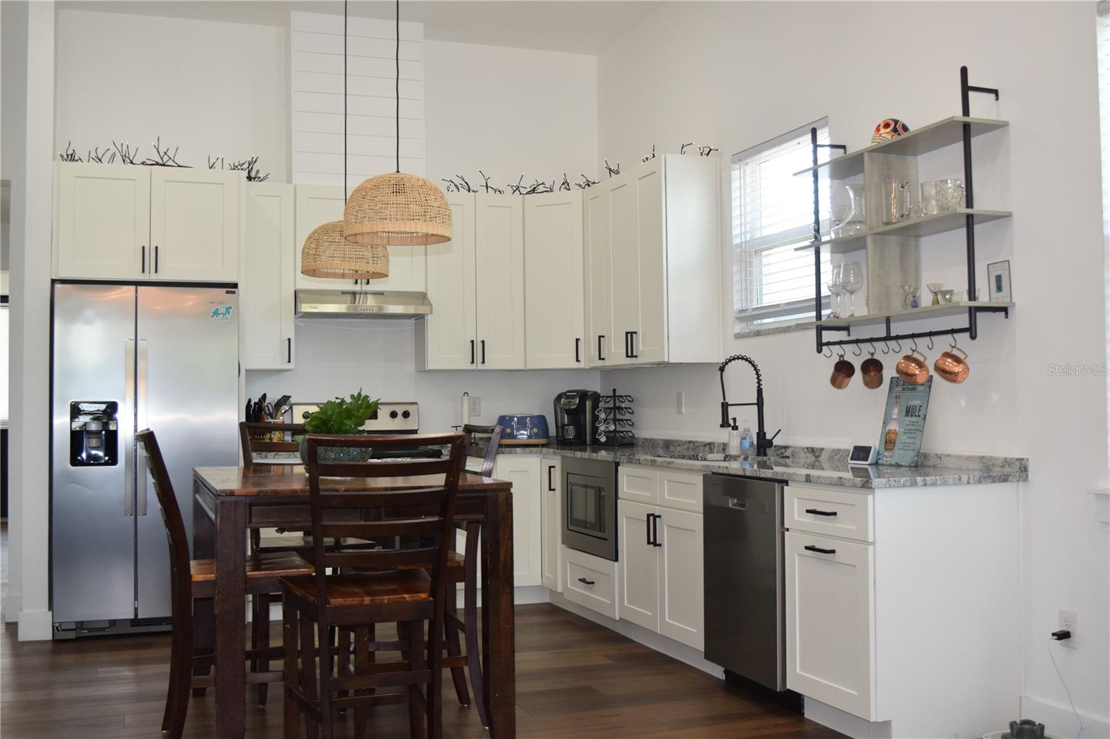 Kitchen is bright and inviting with quality wood cabinets