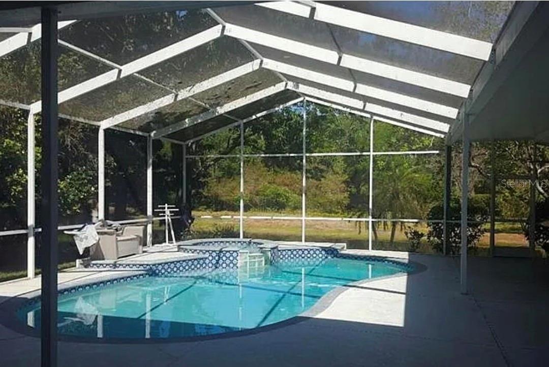 Serene Pool and Spa with outdoor Lanai and lovely pond view