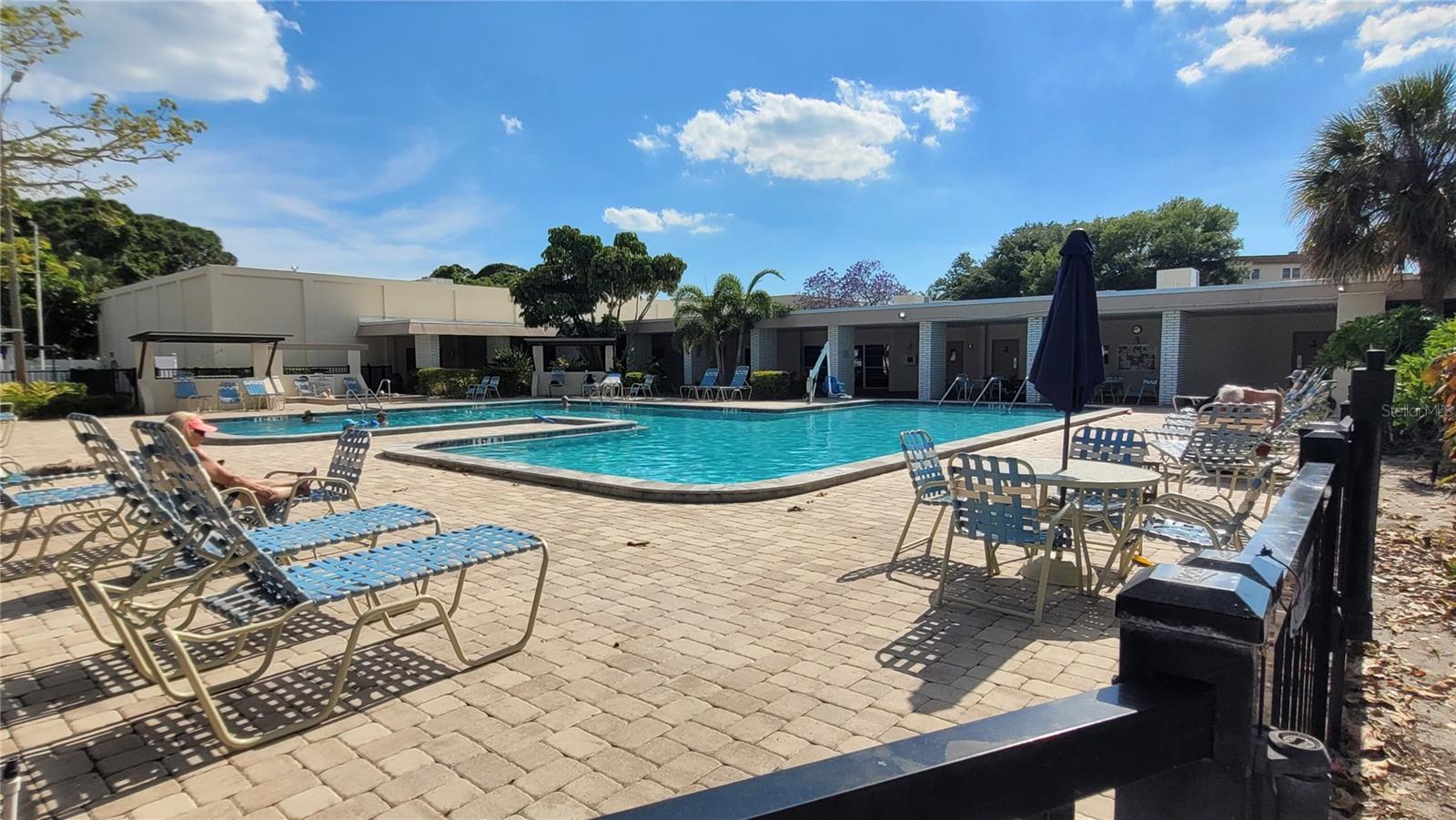 Extra large pool with paver decking and a hot tub