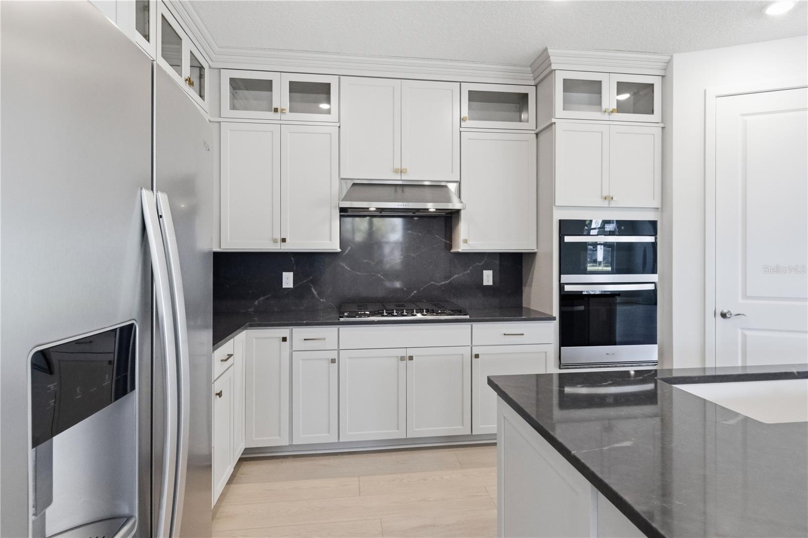 Modern kitchen with bright cabinetry, sleek counters, and a finished design center feel.