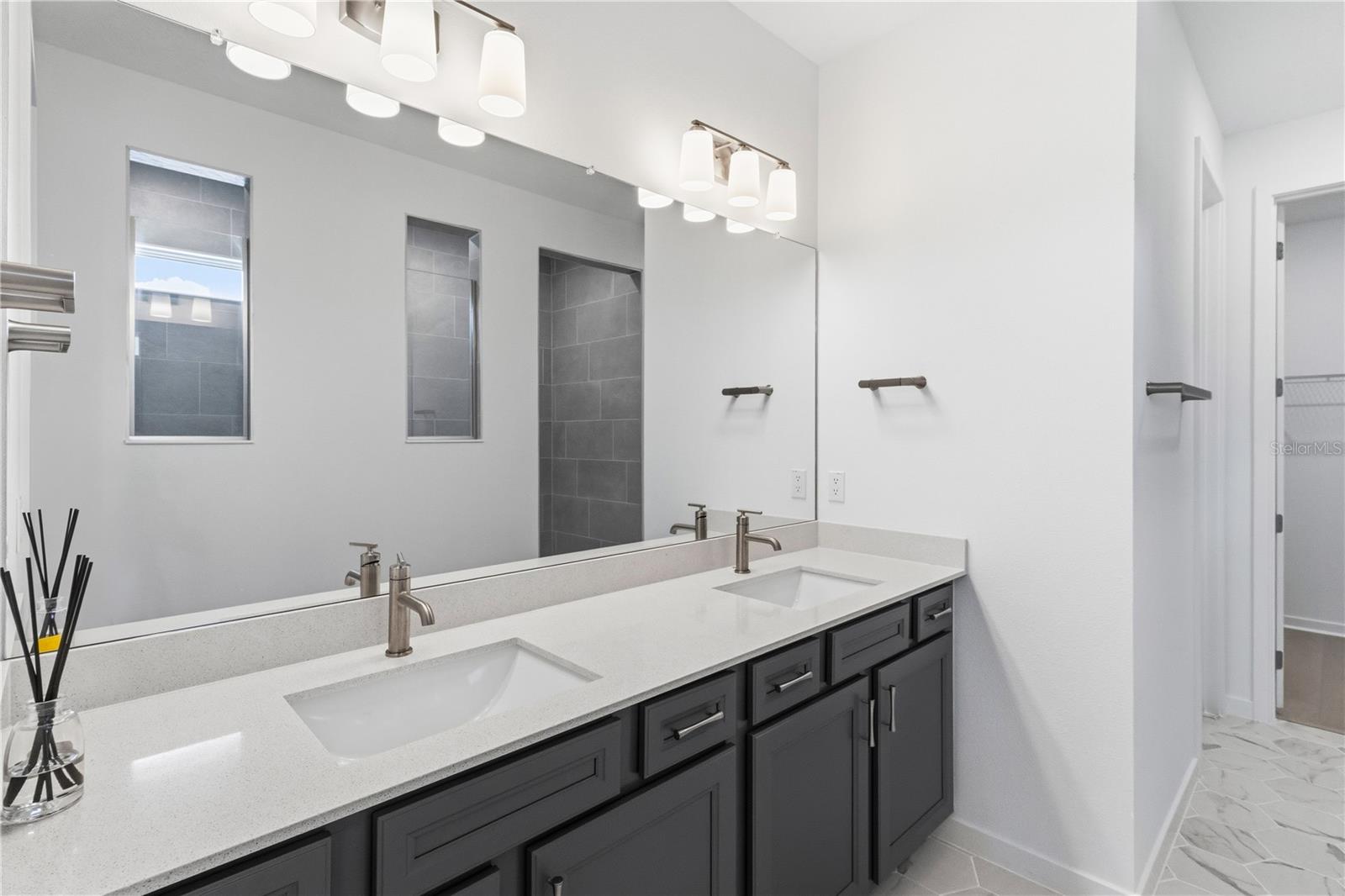 Beautiful primary bath with dual sinks, upgraded finishes, and everyday convenience.