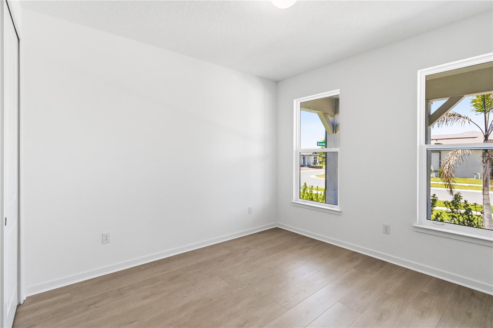 Bright flexible first floor bedroom with warm flooring and natural light for work, hobbies, or everyday use.