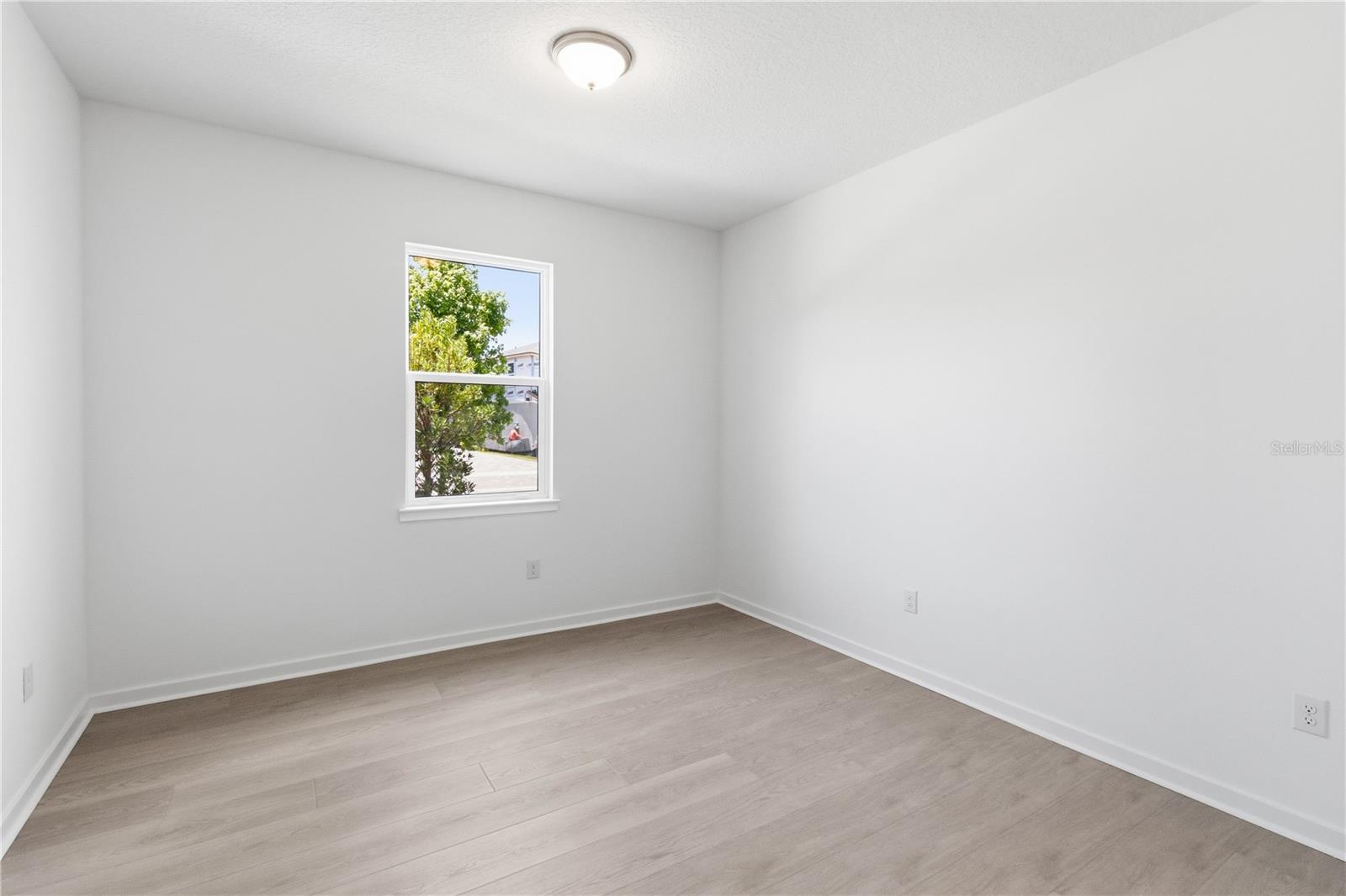 Secondary bedroom with soft natural light and a comfortable, flexible layout.