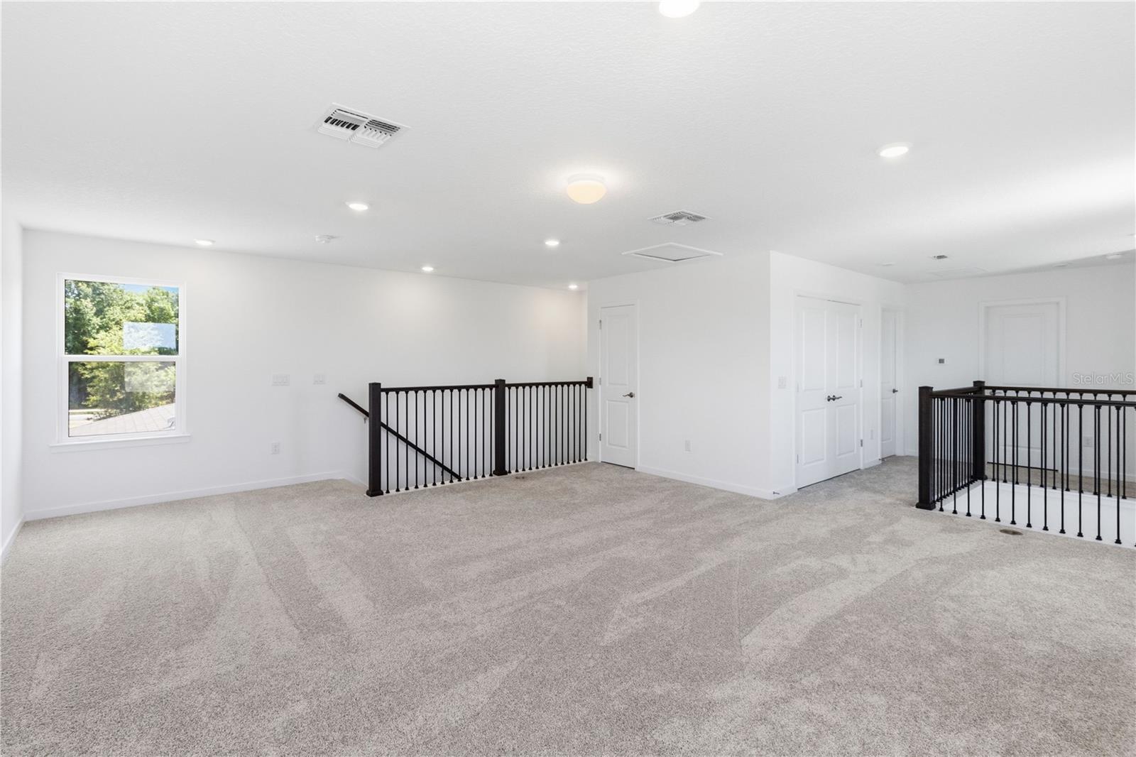 Large upstairs loft with open sightlines and flexible space for a second living area.