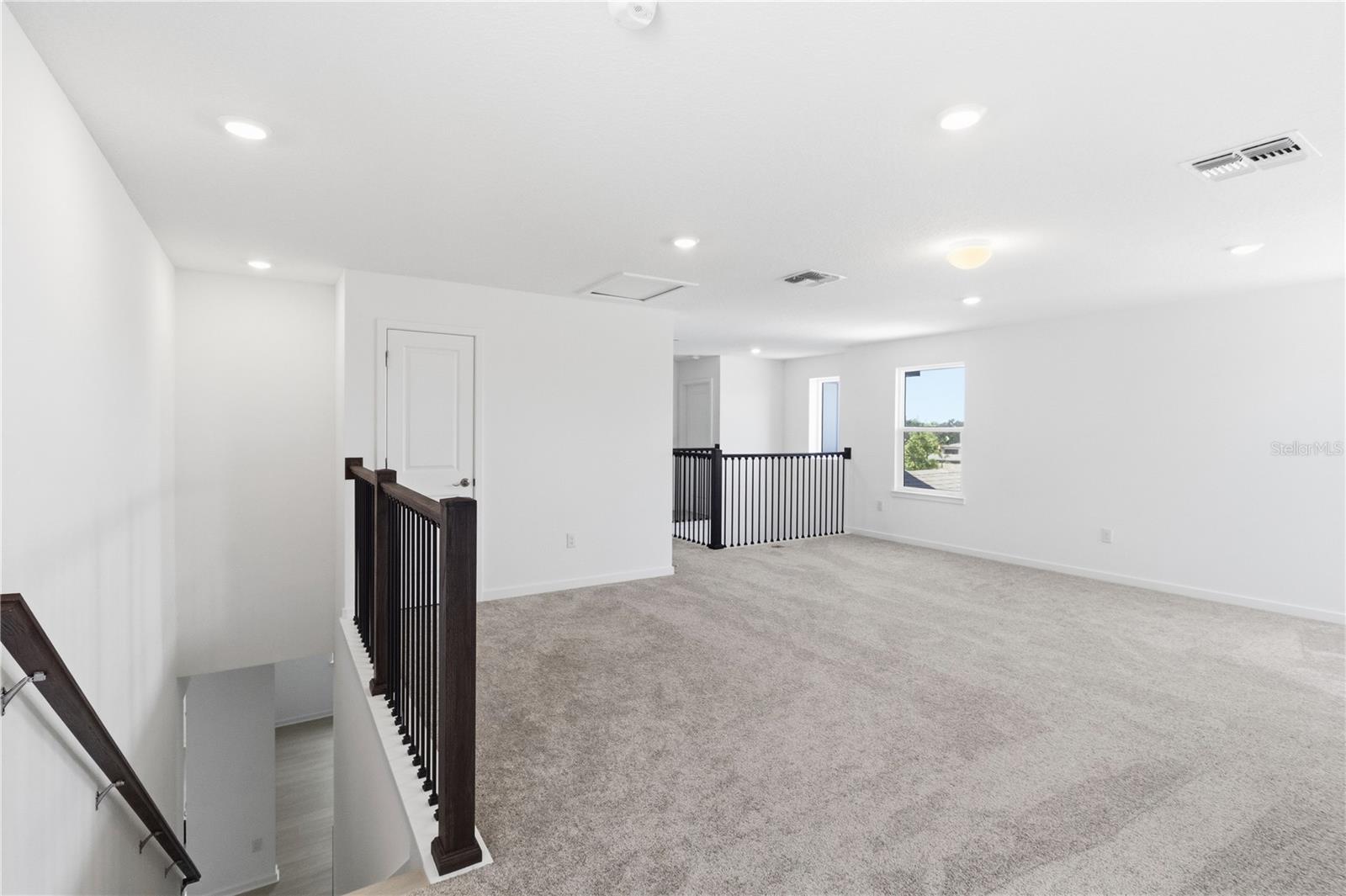 Bright loft area with room to create a media space, play area, homework zone, or lounge.