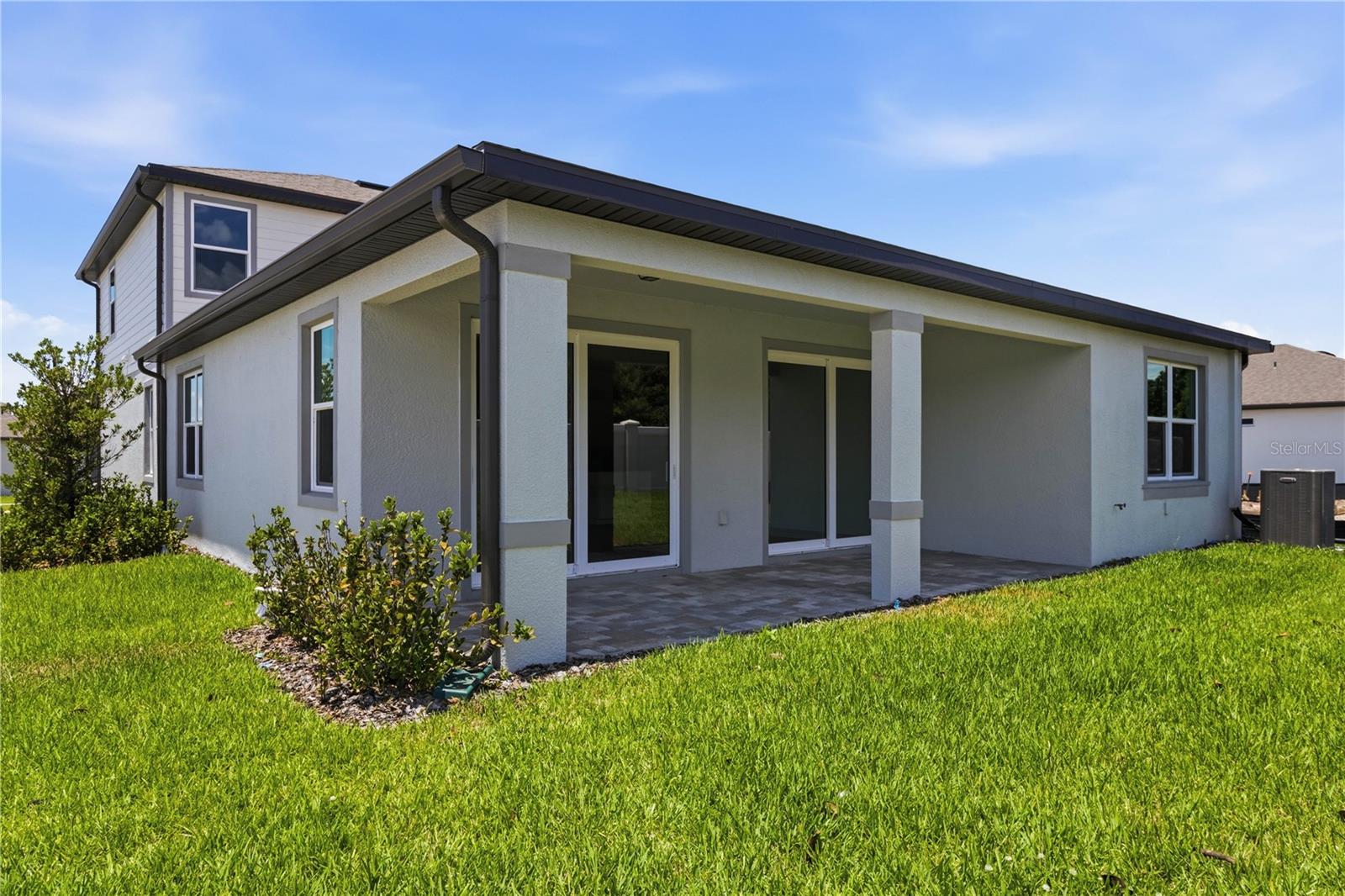 Covered rear lanai and backyard space for grilling, relaxing, and easy Florida evenings.