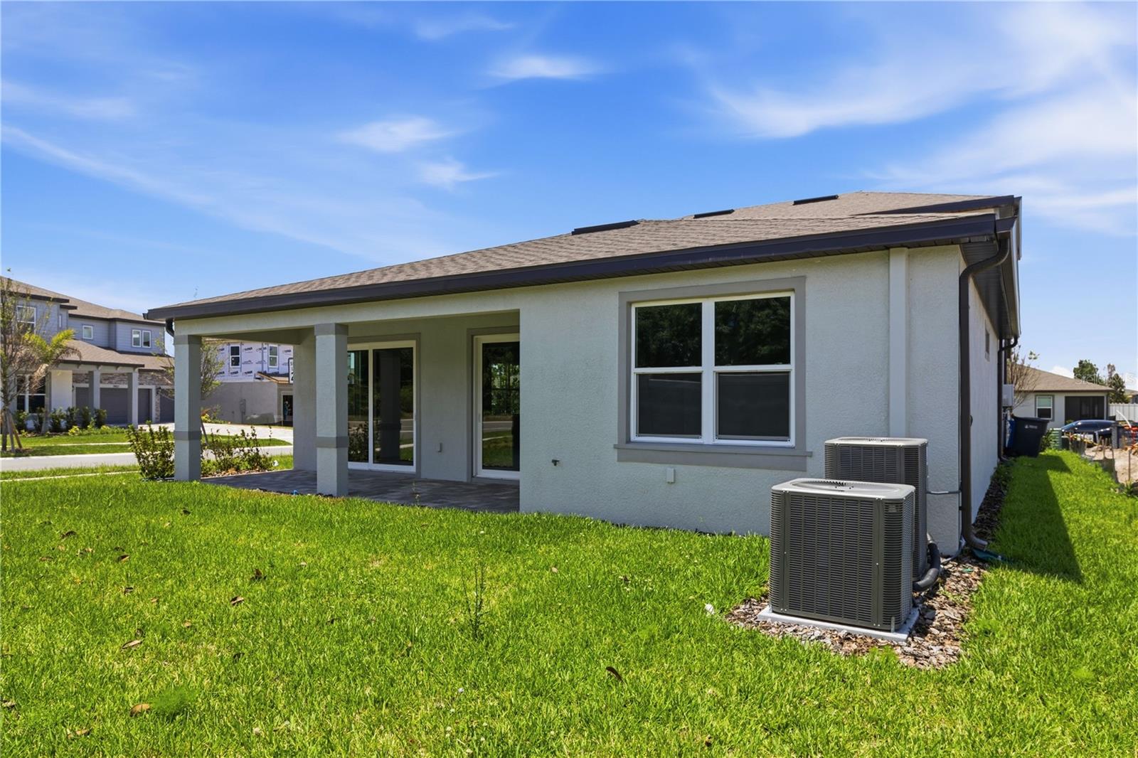 Rear exterior view with covered lanai space and room to enjoy the backyard.