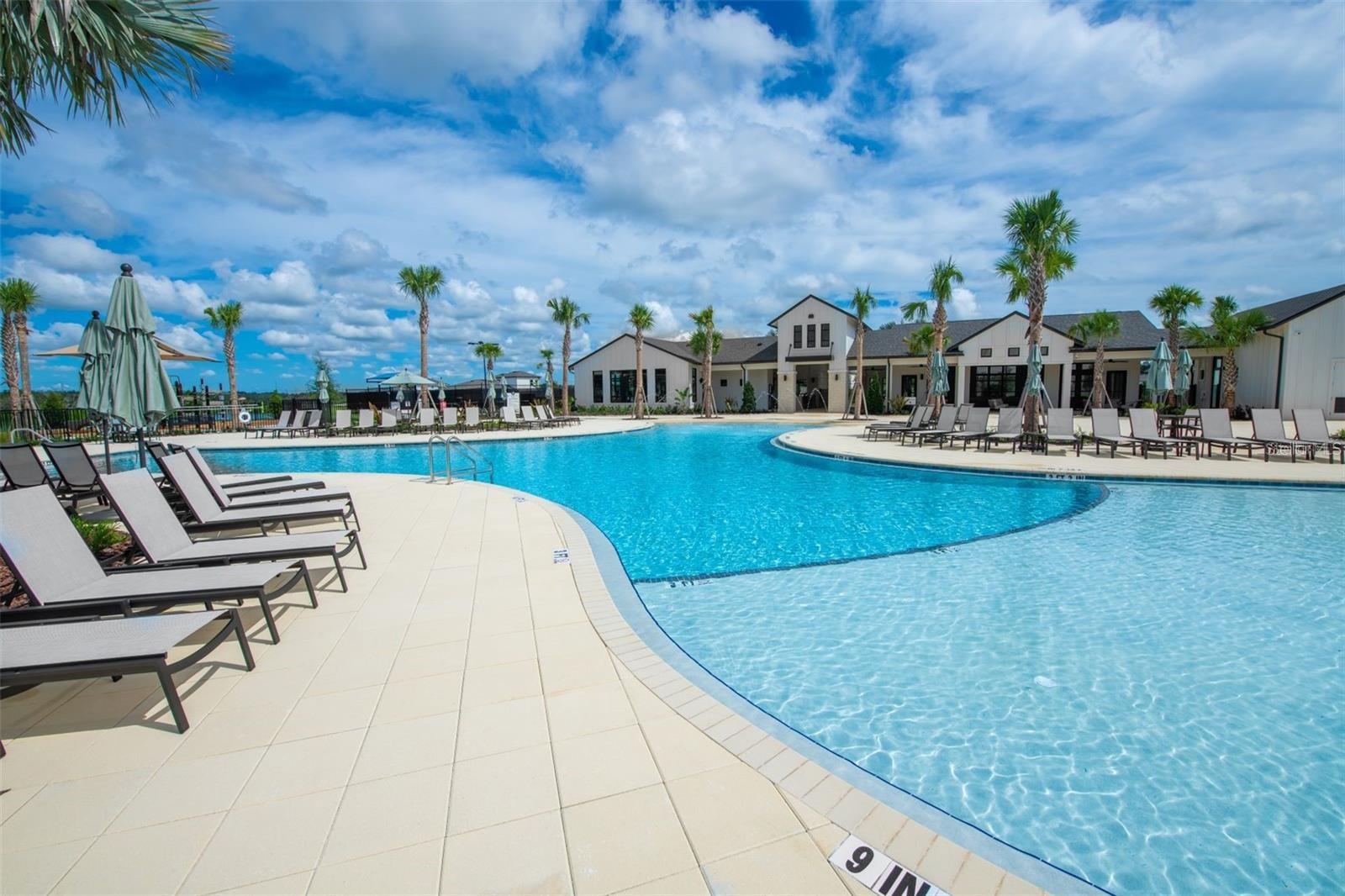 Spacious community pool with lounge areas for sunny afternoons and weekend fun.