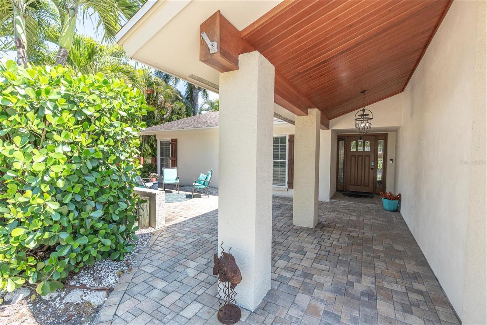 Large covered porch with tongue and groove ceiling and hanging porch light.