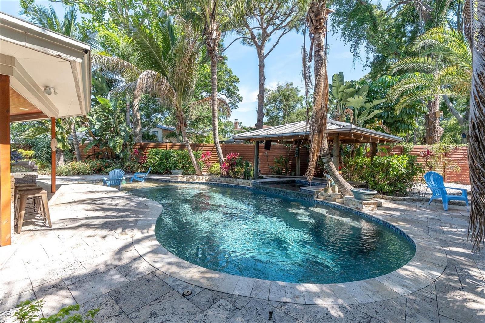 A tropical oasis surrounded by swaying palms.
