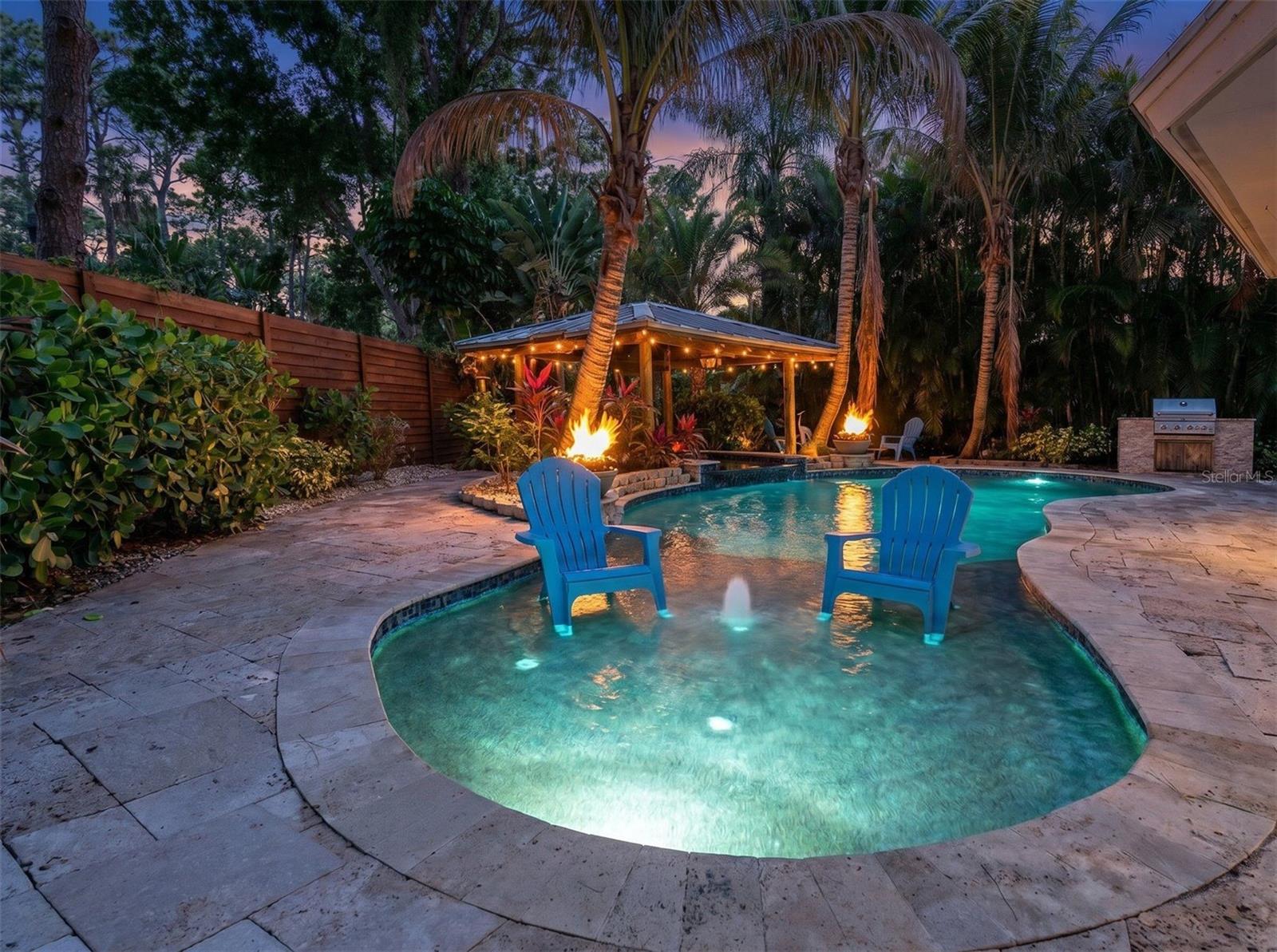 Resort-style pool with dramatic fire features.