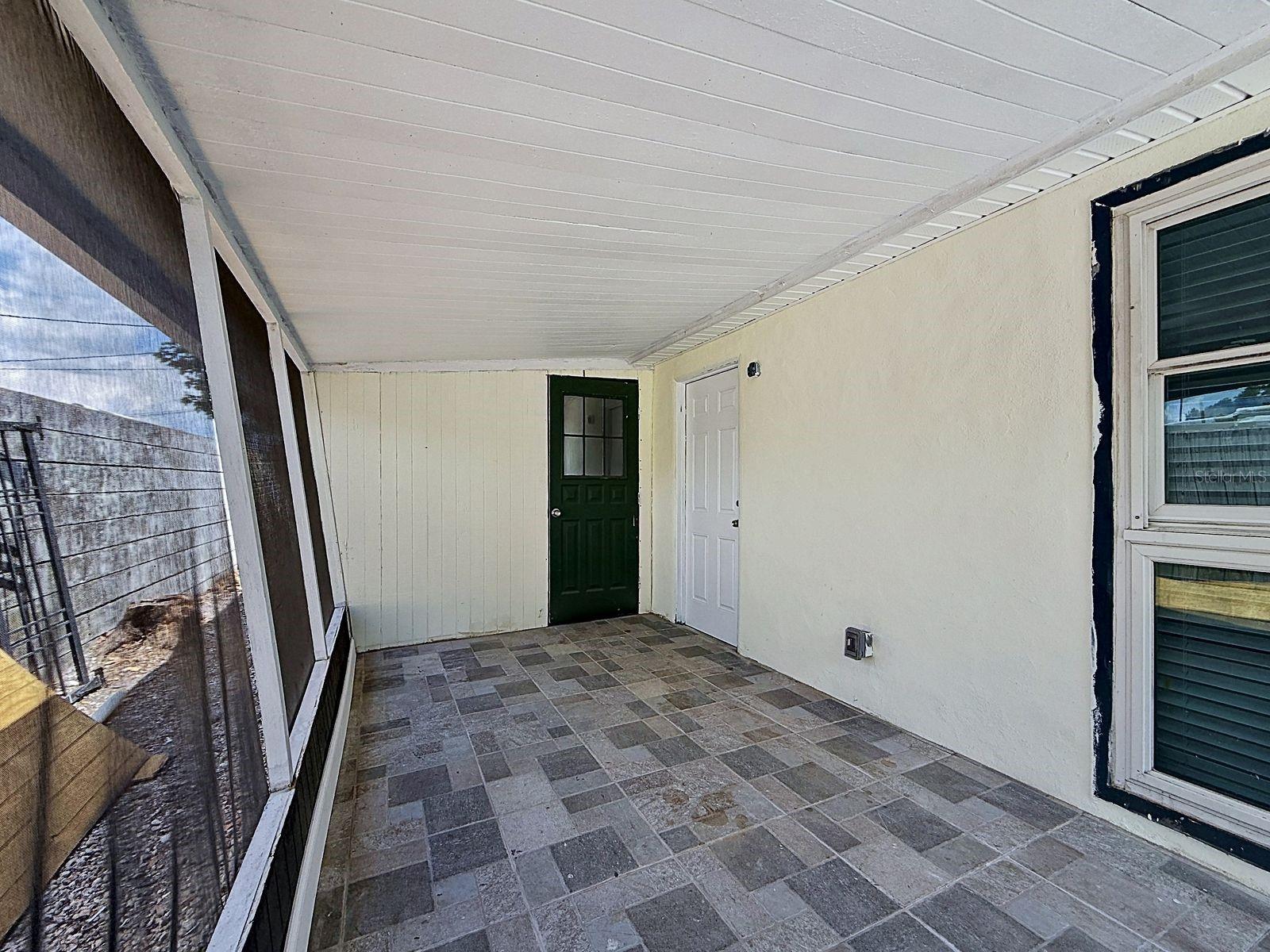 Screened-In Patio includes a separate storage room, perfect for additional storage or a workshop