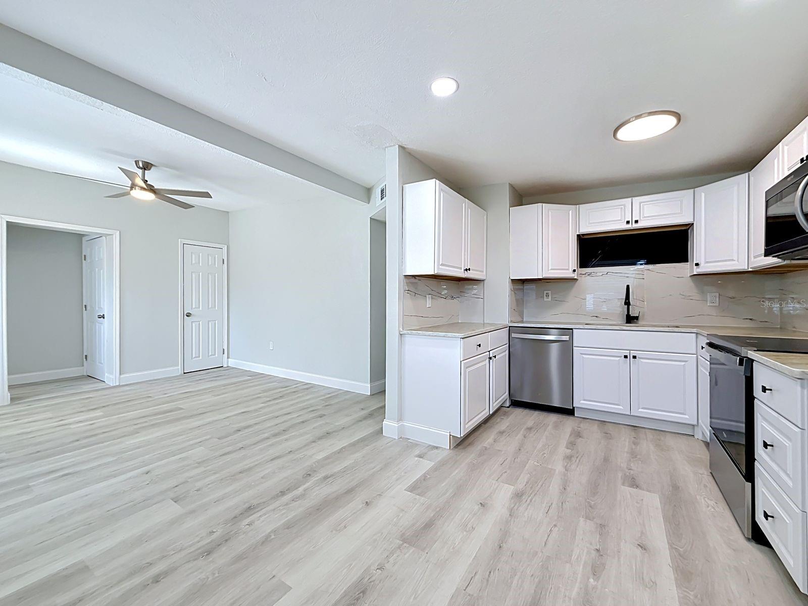 View from dining area into living room and kitchen