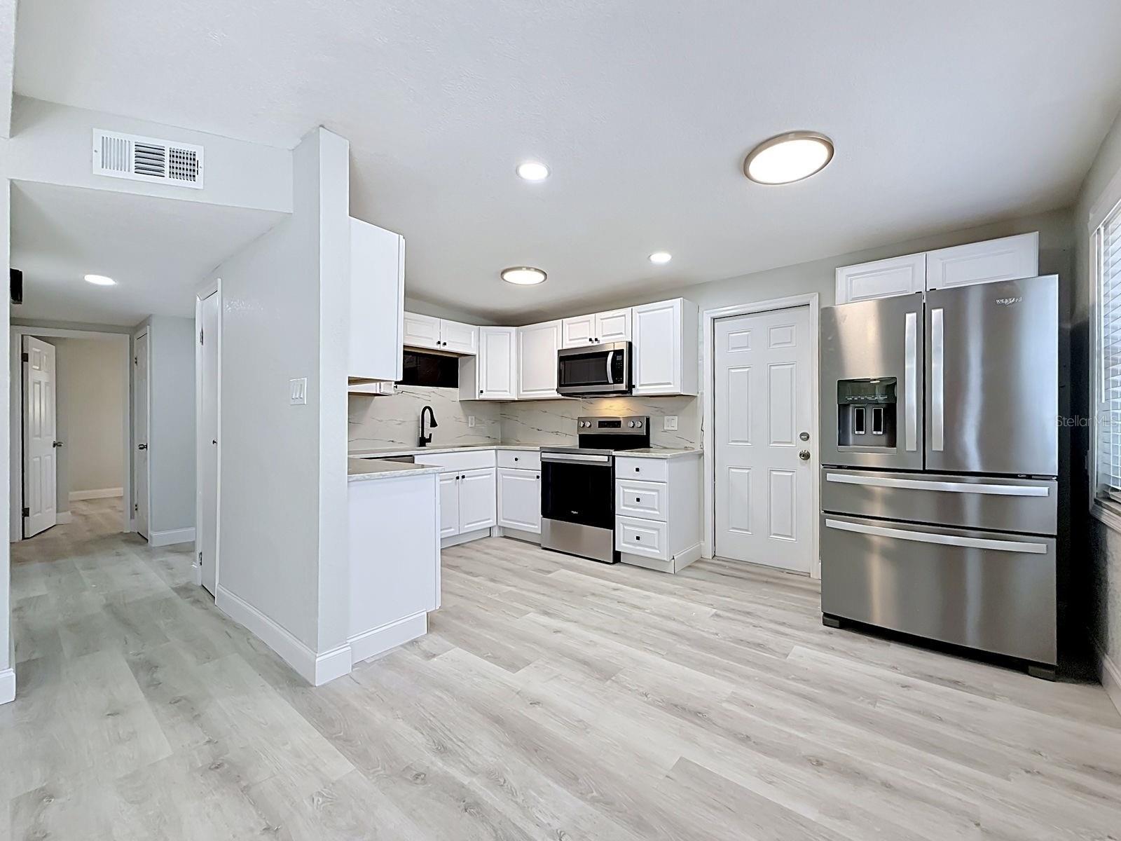 Open Floor Plan - View from living room into dining area and kitchen