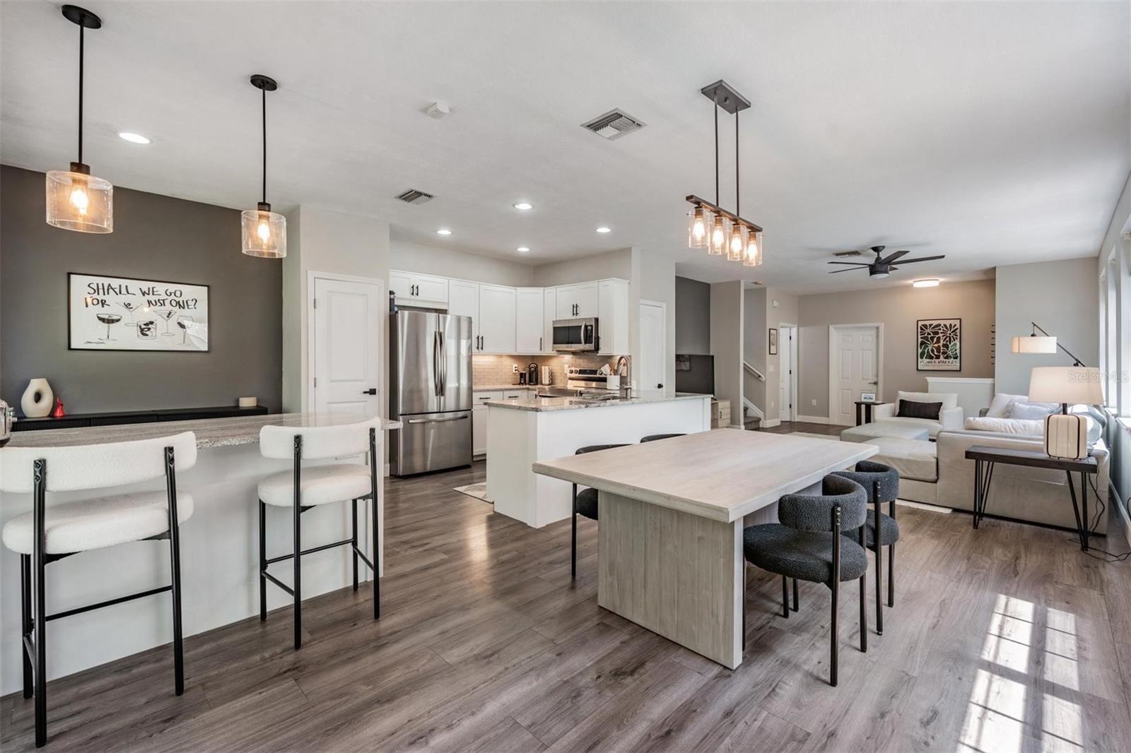 Kitchen/Dining combo with upgraded lighting and luxury vinyl flooring throughout