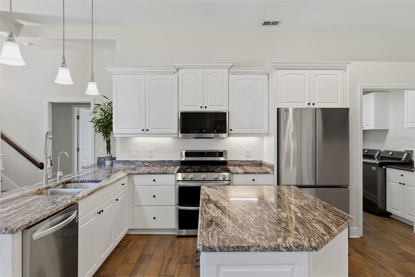 Kitchen is light bright and airy with views to the living room, great room and outdoor space