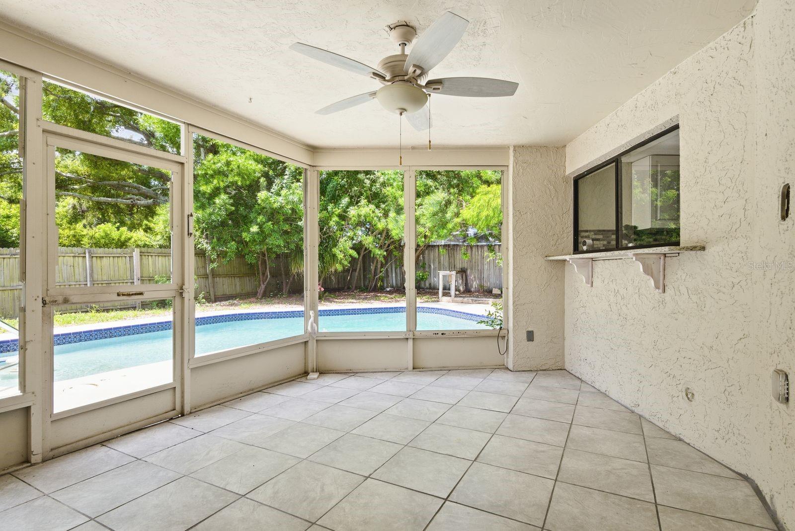 Screened lanai with pass through window from kitchen