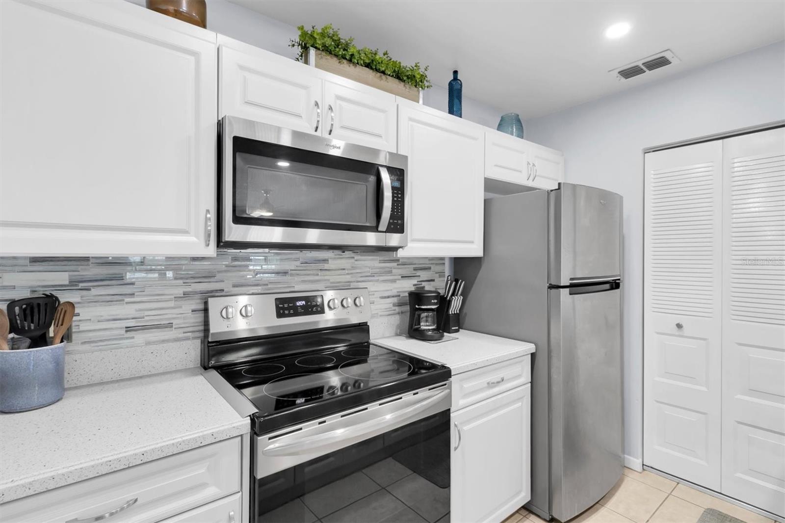 Galley Kitchen with stainless steel appliances