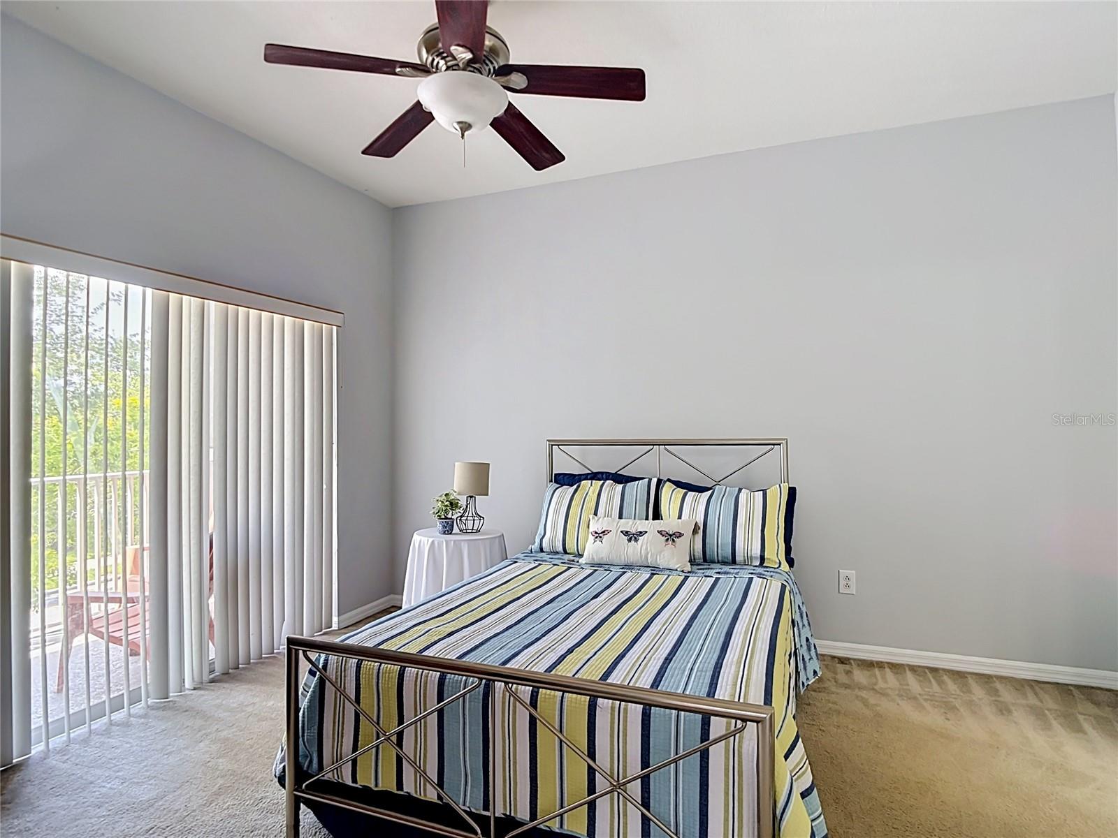 9502 W Park Village 108, primary bedroom, slider to balcony on left