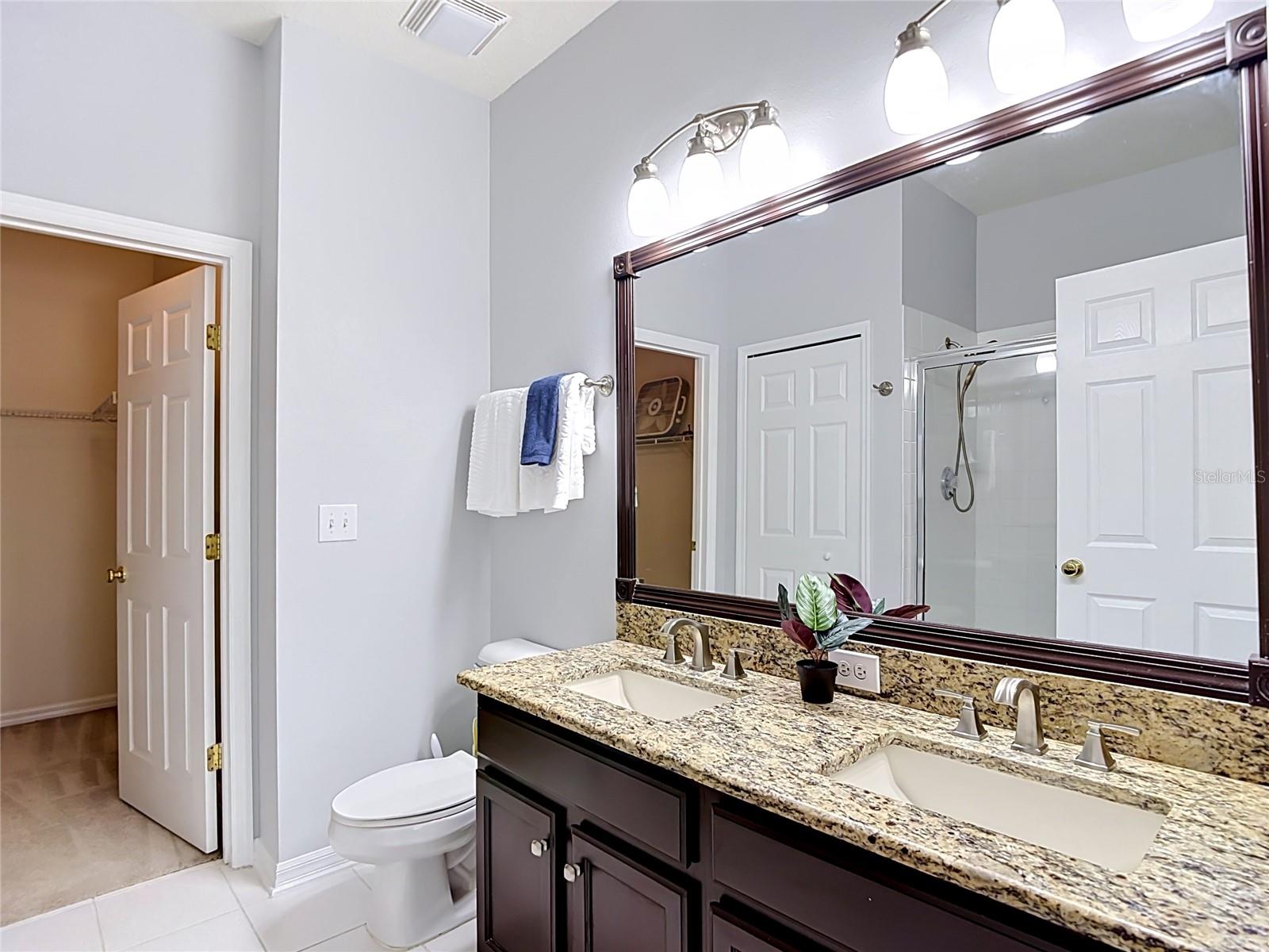 9502 W Park Village 108, primary bath, dual sinks, walk in closet to left