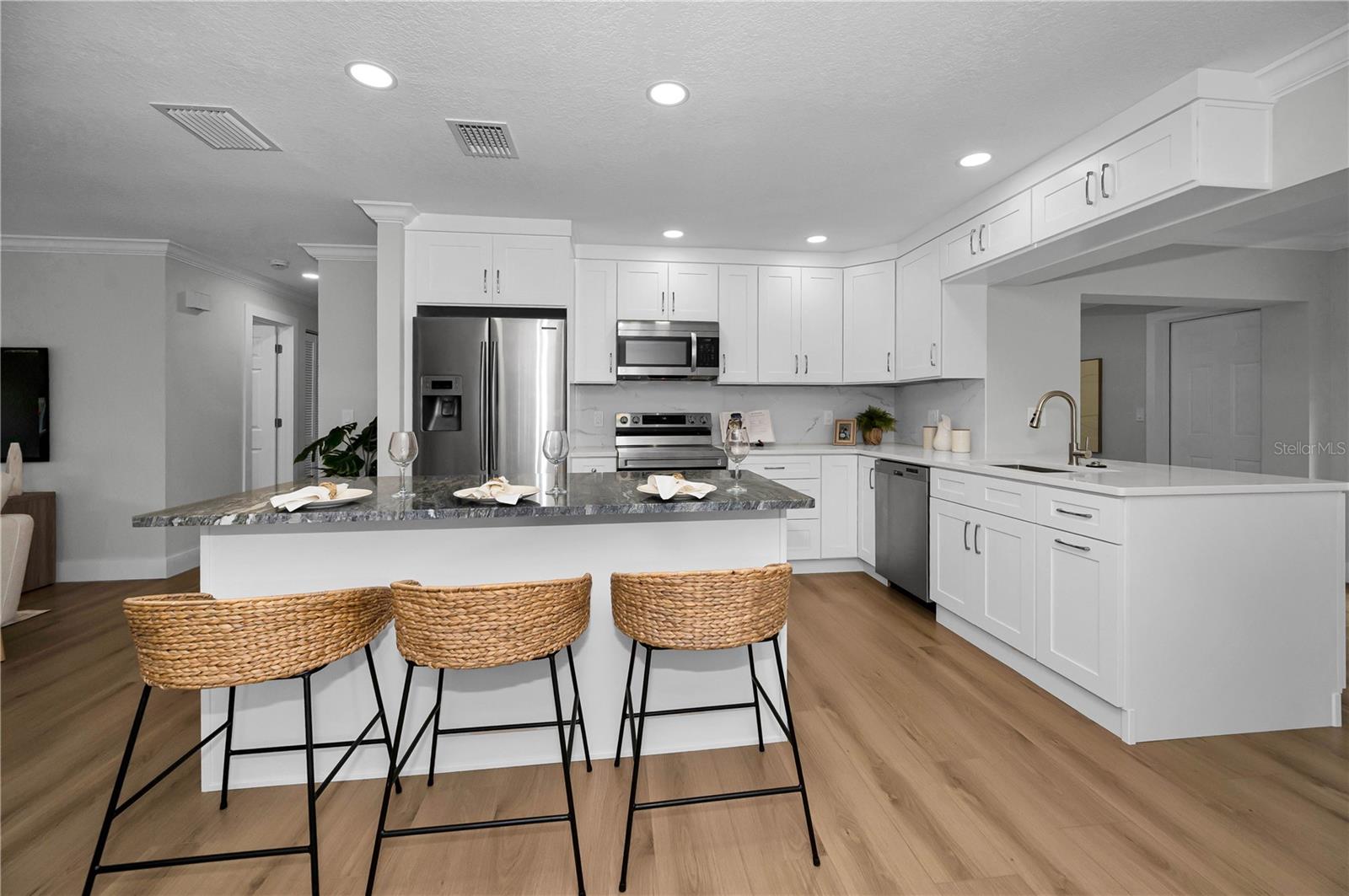 Solid surface countertops, soft close cabinets, with well thought out traffic flow.