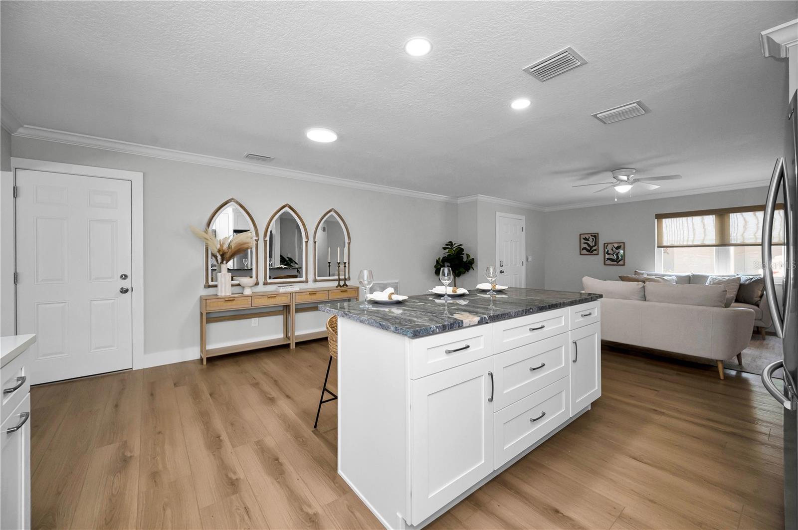 Door to left leads to garage and indoor laundry area while the kitchen island offers plenty of additional storage.