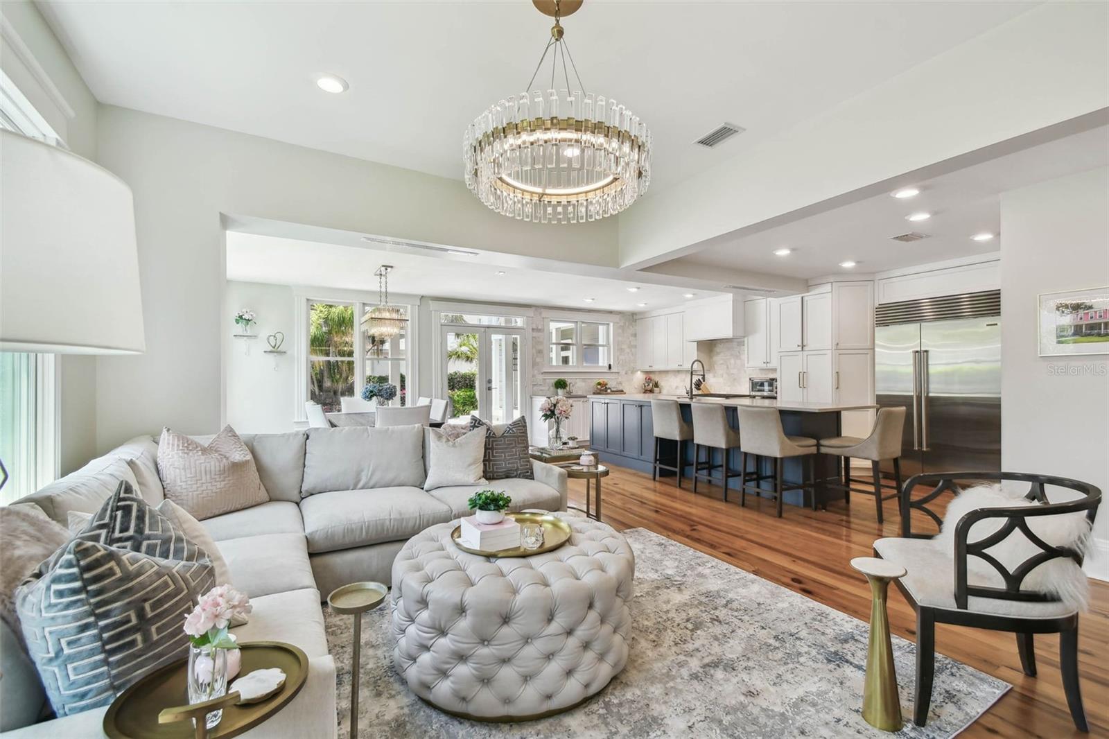 Looking from the family room towards the dining area on the left, the kitchen on the right, and the French doors in the center leading to the rear porch and pool area.