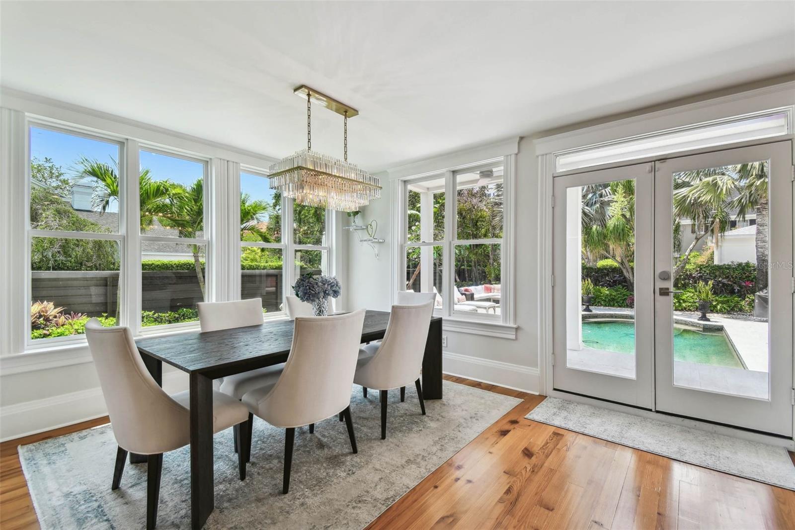 Dining area.  Note the superior amount of natural light in this room and the views of the pool area and side yard landscaping.