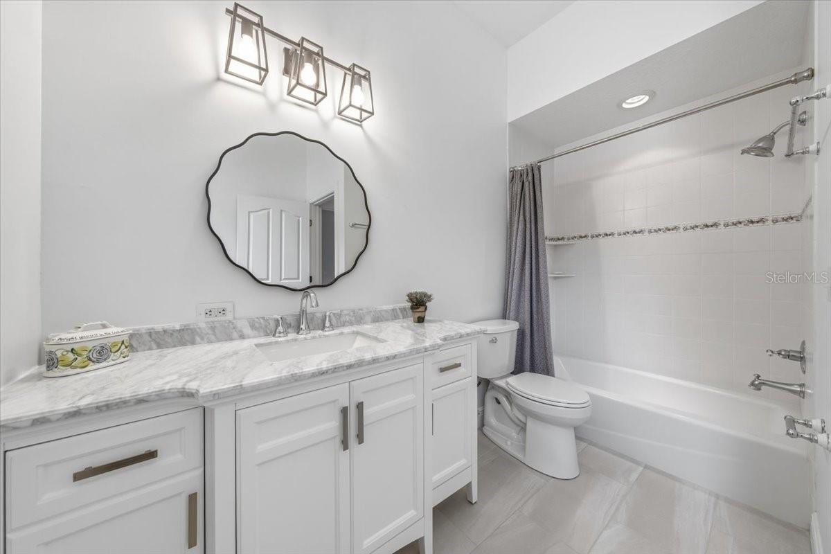 Elegant granite surfaces throughout bathroom