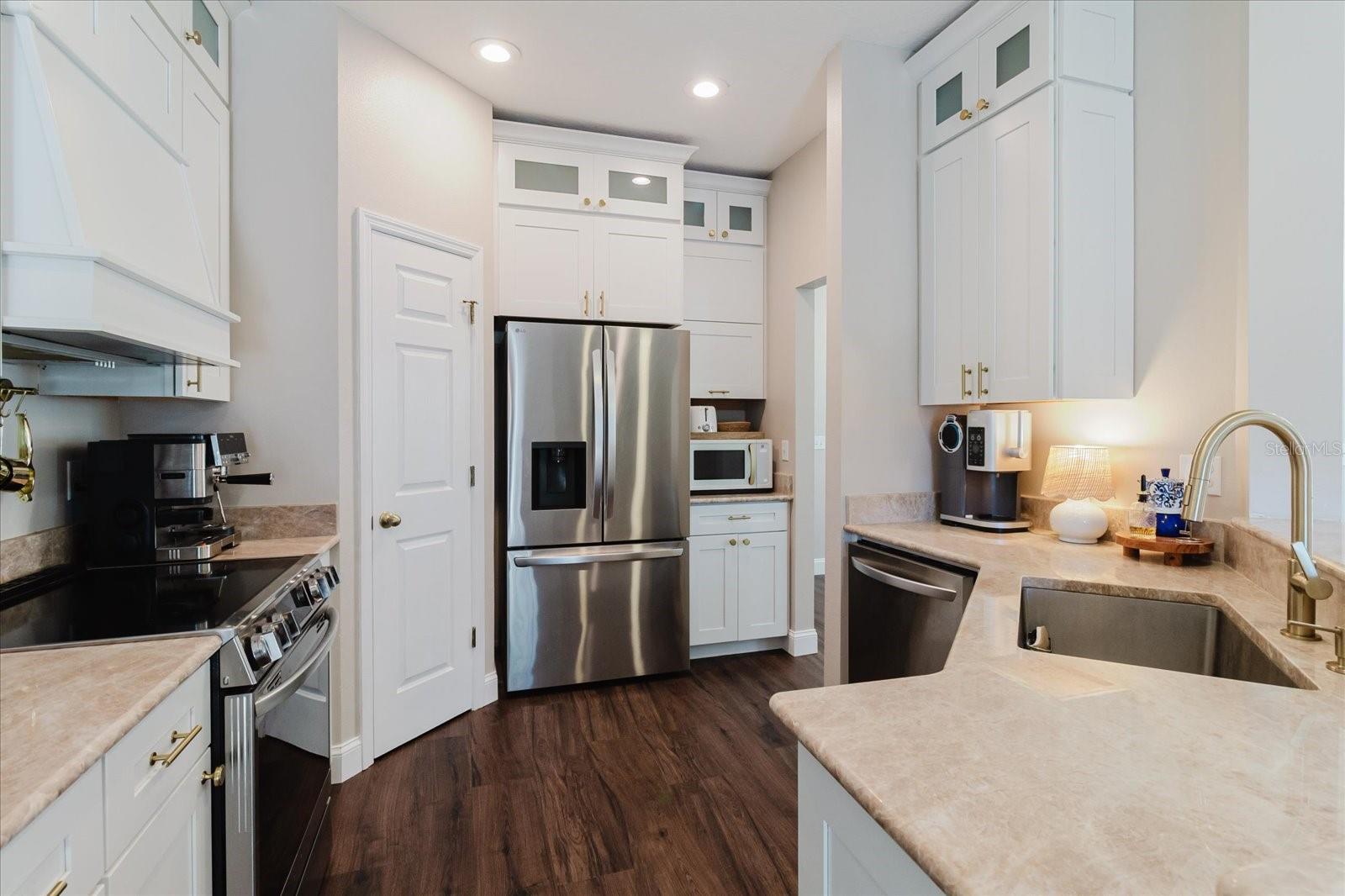 Quartzite Counters, Kraftmaid Dovetailed Cabinetry With Soft Close  and Crown Molding Around The Cabinets, Stainless Steel Appliances