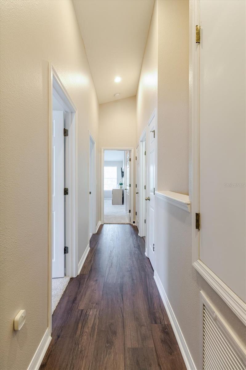 Upstairs Hallway Leads To The Primary Ensuite Bedroom & Two Guest Bedrooms and 2nd Full Bath