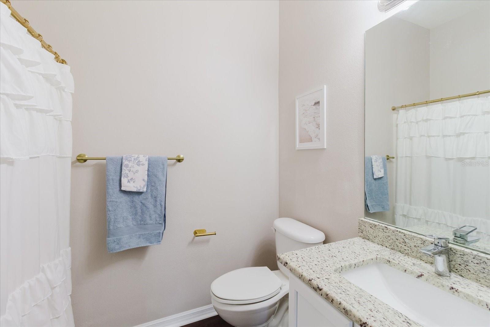 2nd Upstairs Bath With A Single Granite Counter Vanity, Luxury Vinyl Floors, & A Tub/Shower Combo