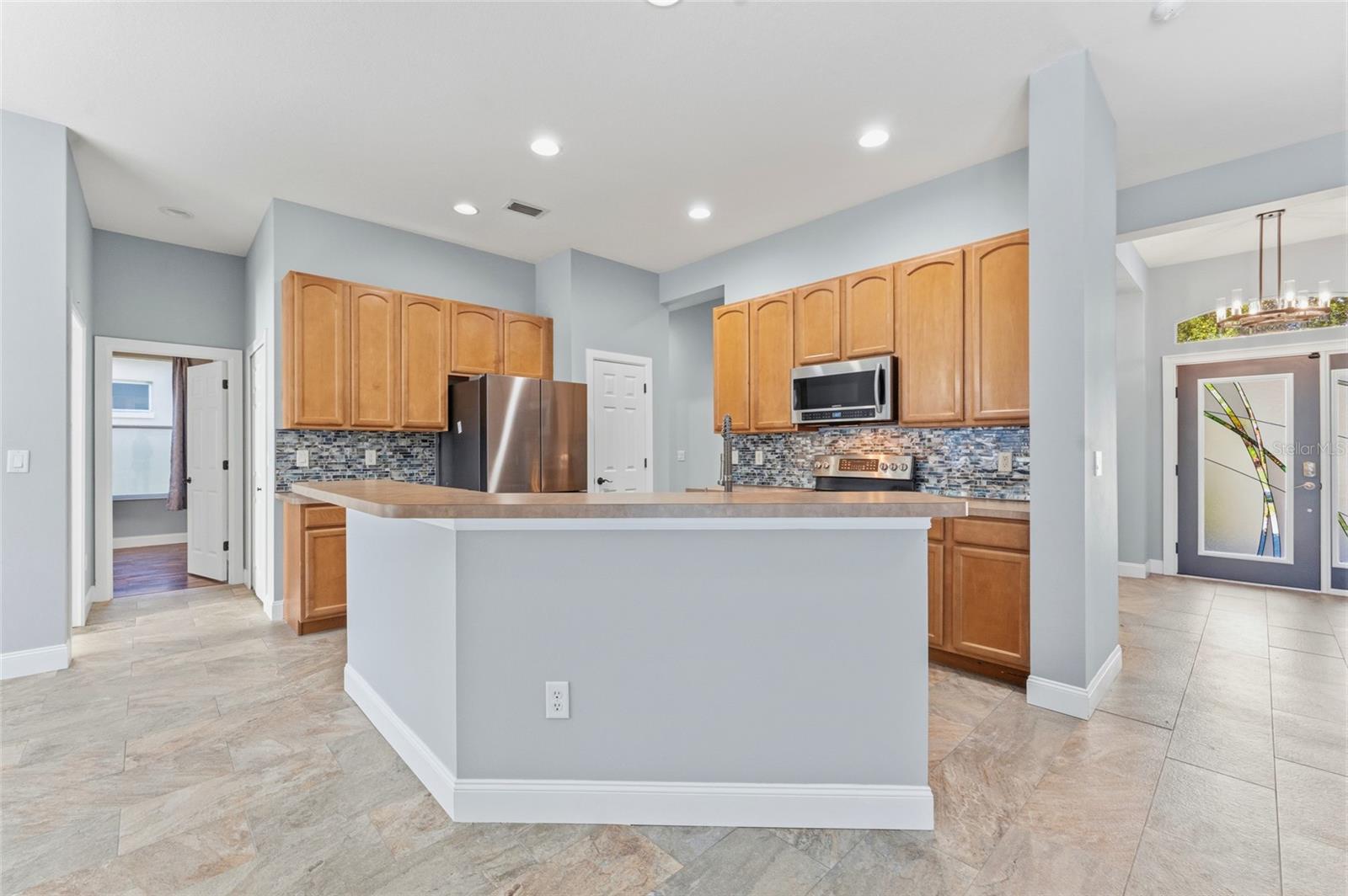Nicely updated kitchen with 42" uppers glass tile backsplash