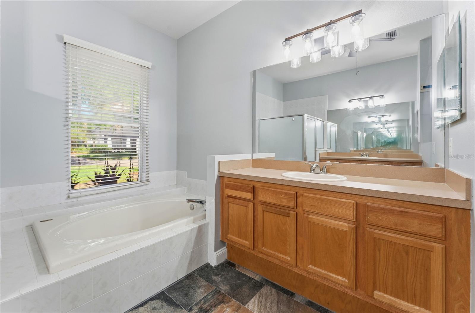 Primary bath features split vanities and private water closet