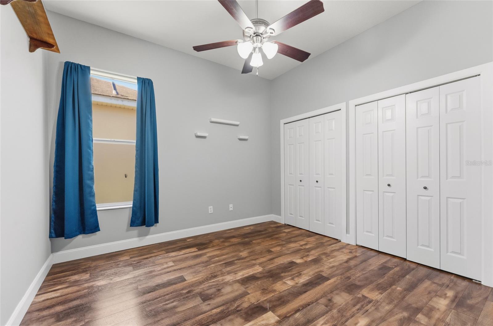 Bedroom 3 with dual closets and ceiling fan