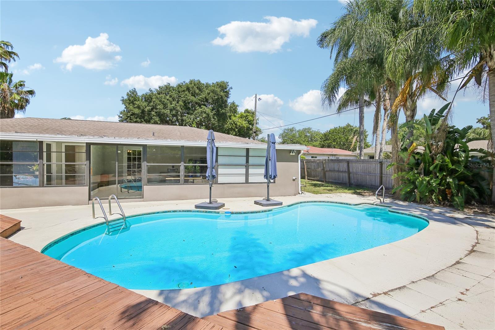 Backyard Pool View – This wide view highlights the spacious pool area, surrounding patio, and easy connection to the home’s poolside bonus room. Multiple access points and open deck space make the backyard well suited for outdoor enjoyment.
