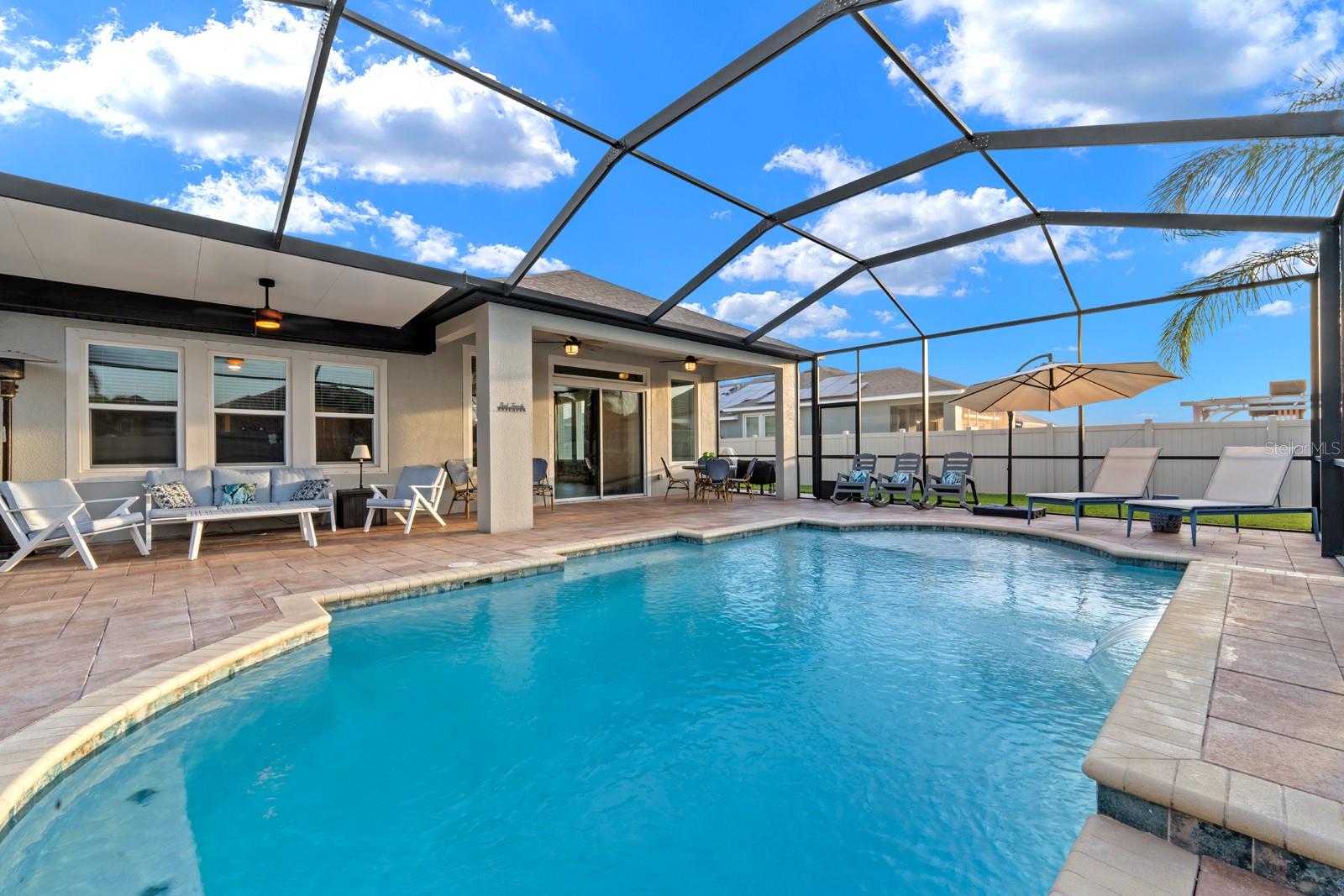 Pool with sun ledge, fenced in back yard